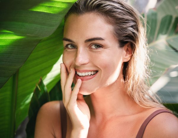 Beautiful and natural looking woman with tropical banana leaves